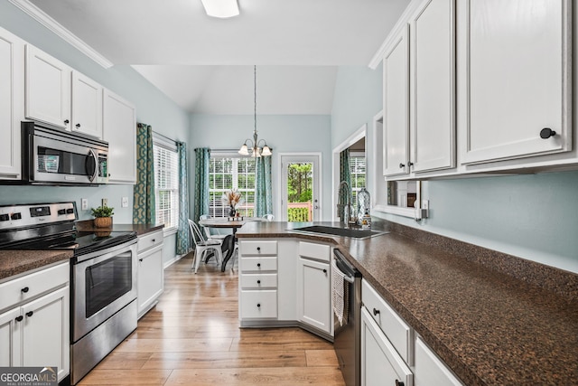 167 Maggies Pt, Dallas, GA 30132 - kitchen with appliances with stainless steel finishes, dark countertops, a chandelier, light wood-type flooring, and vaulted ceiling