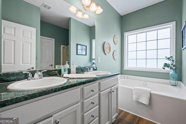 167 Maggies Pt, Dallas, GA 30132 - bathroom featuring double vanity, a garden tub, wood finished floors, and a shower