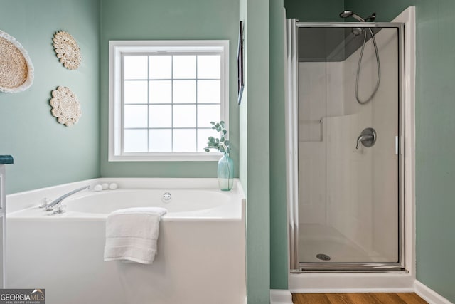 167 Maggies Pt, Dallas, GA 30132 - full bathroom with a stall shower, a bath, and wood finished floors