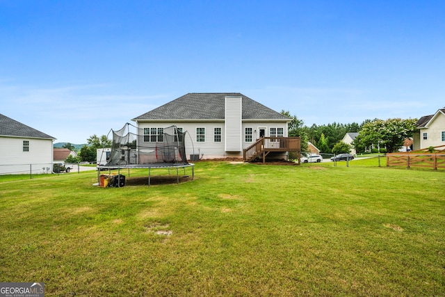 167 Maggies Pt, Dallas, GA 30132 - rear view of property featuring a trampoline, a deck, a fenced backyard, and roof with shingles