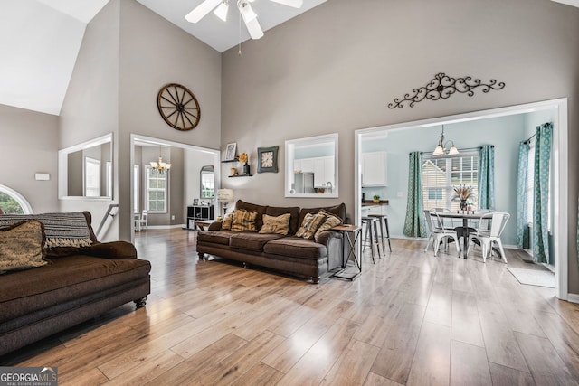 167 Maggies Pt, Dallas, GA 30132 - living area with a chandelier, high vaulted ceiling, ceiling fan, light wood finished floors, and plenty of natural light