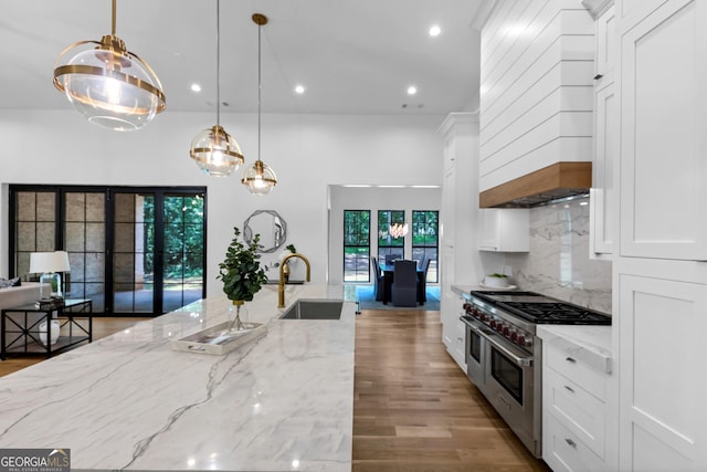 4235 Drew Campground Rd, Alpharetta, GA 30004 - kitchen with range with two ovens, white cabinetry, recessed lighting, custom exhaust hood, and pendant lighting
