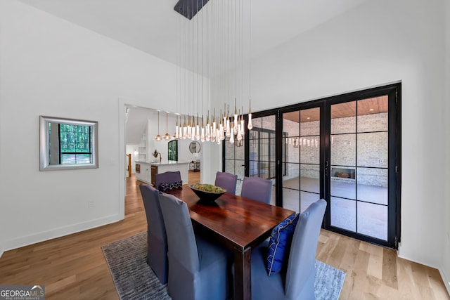 4235 Drew Campground Rd, Alpharetta, GA 30004 - dining room with a high ceiling, light wood-type flooring, and a chandelier
