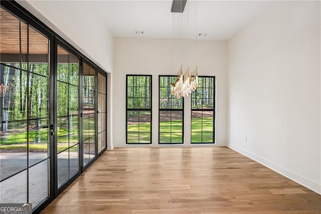 4235 Drew Campground Rd, Alpharetta, GA 30004 - unfurnished room with light wood-style floors and a chandelier