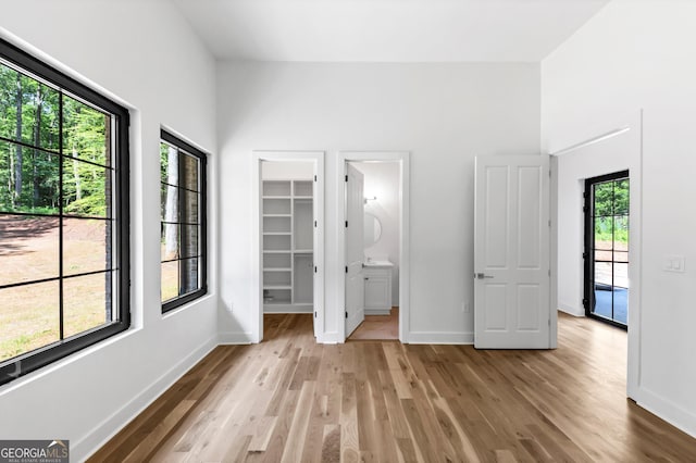 4235 Drew Campground Rd, Alpharetta, GA 30004 - unfurnished bedroom featuring light wood-style flooring, a spacious closet, and a closet