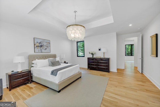 4235 Drew Campground Rd, Alpharetta, GA 30004 - bedroom with multiple windows, light wood-type flooring, a chandelier, recessed lighting, and a raised ceiling