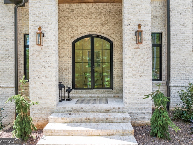 4235 Drew Campground Rd, Alpharetta, GA 30004 - view of exterior entry with french doors, covered porch, and brick siding