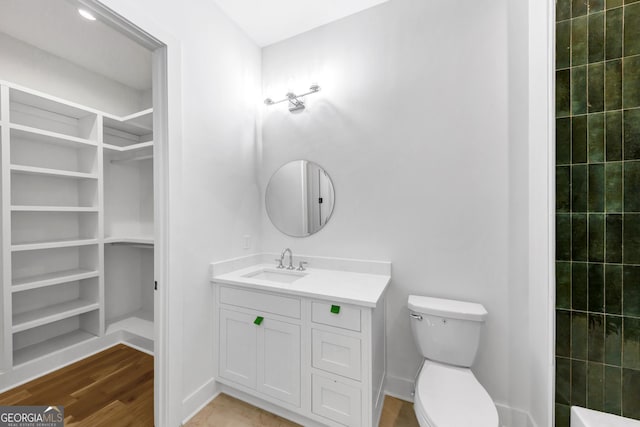4235 Drew Campground Rd, Alpharetta, GA 30004 - bathroom featuring vanity, wood finished floors, a spacious closet, and a shower