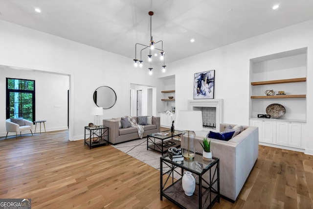 4235 Drew Campground Rd, Alpharetta, GA 30004 - living room featuring built in shelves, light wood-style flooring, recessed lighting, and a fireplace