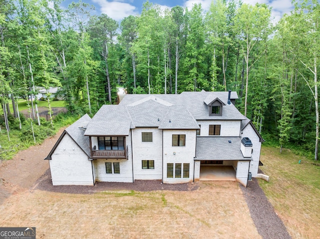 4235 Drew Campground Rd, Alpharetta, GA 30004 - rear view of house with a balcony, a shingled roof, and driveway