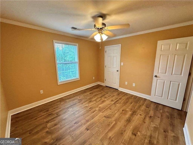 105 Whitehead Rd Unit 10, Athens, GA 30606 - unfurnished bedroom featuring wood finished floors, ornamental molding, baseboards, and ceiling fan