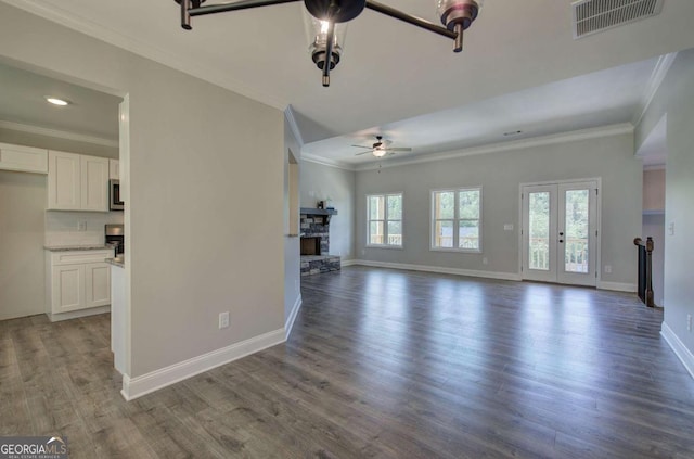 315 Arbor Cir, Rockmart, GA 30153 - unfurnished living room with crown molding, a ceiling fan, a stone fireplace, baseboards, and wood finished floors