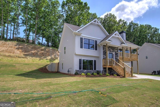 315 Arbor Cir, Rockmart, GA 30153 - view of front facade with stone siding, board and batten siding, a front yard, concrete driveway, and stairs