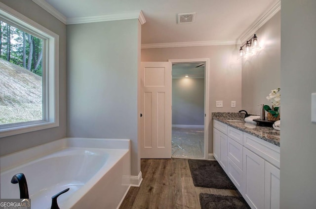 315 Arbor Cir, Rockmart, GA 30153 - bathroom featuring wood finished floors, double vanity, a bath, ornamental molding, and baseboards