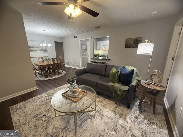 3915 Woodridge Way, Tucker, GA 30084 - living area with ceiling fan, wood finished floors, a chandelier, and a textured ceiling