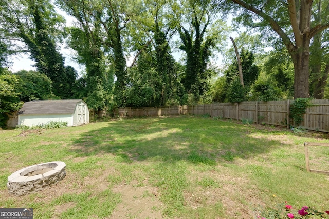 256 4th Ave, Winder, GA 30680 - fenced backyard with a fire pit and a storage unit