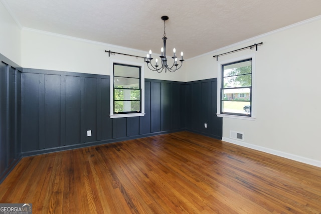 256 4th Ave, Winder, GA 30680 - spare room with a chandelier, wood finished floors, a wainscoted wall, a decorative wall, and ornamental molding
