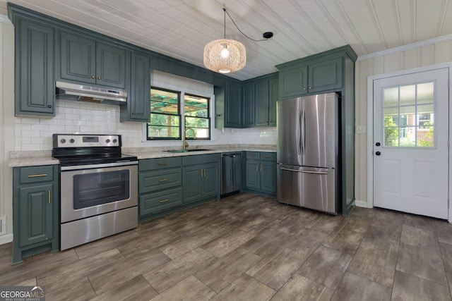 256 4th Ave, Winder, GA 30680 - kitchen featuring appliances with stainless steel finishes, under cabinet range hood, backsplash, crown molding, and pendant lighting