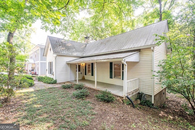 546 Pulaski St, Athens, GA 30601 - view of front facade featuring metal roof, a porch, and a chimney