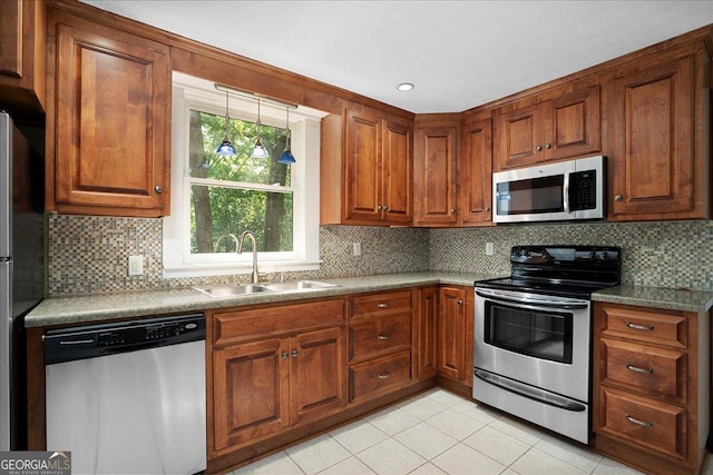 546 Pulaski St, Athens, GA 30601 - kitchen with appliances with stainless steel finishes, a sink, light tile patterned flooring, and brown cabinetry