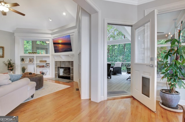 505 Lighthouse Ln, Peachtree City, GA 30269 - living room with light wood finished floors, a ceiling fan, a tile fireplace, and recessed lighting