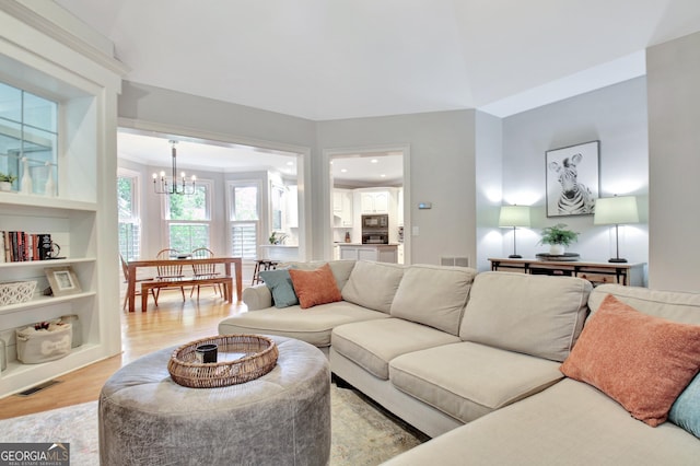 505 Lighthouse Ln, Peachtree City, GA 30269 - living room with a chandelier and light wood-style flooring