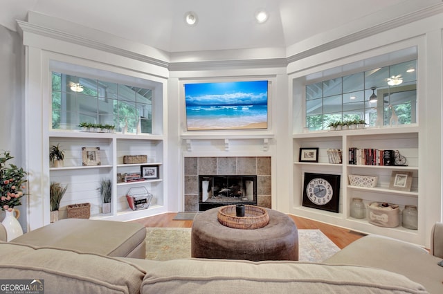 505 Lighthouse Ln, Peachtree City, GA 30269 - living area with wood finished floors, built in features, a tile fireplace, lofted ceiling, and recessed lighting