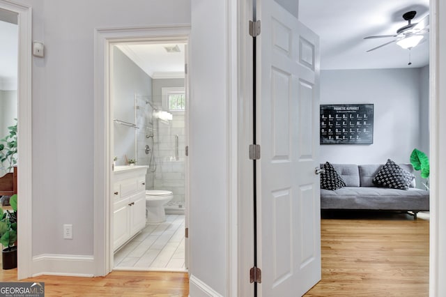 505 Lighthouse Ln, Peachtree City, GA 30269 - hallway with light wood-type flooring, baseboards, and ornamental molding