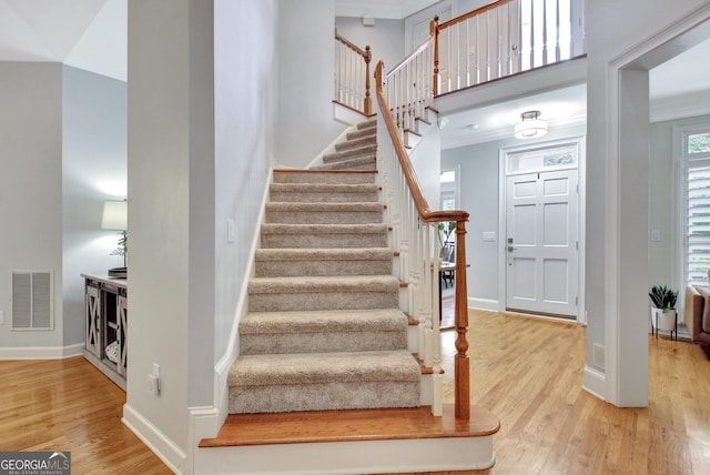 505 Lighthouse Ln, Peachtree City, GA 30269 - stairway featuring wood finished floors, baseboards, and a towering ceiling