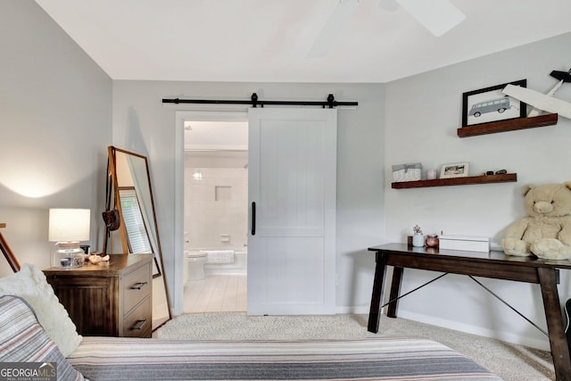 505 Lighthouse Ln, Peachtree City, GA 30269 - bedroom featuring a barn door, connected bathroom, carpet, and ceiling fan