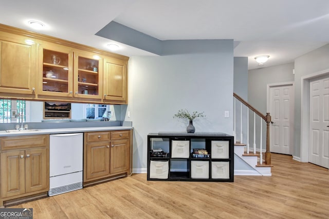 505 Lighthouse Ln, Peachtree City, GA 30269 - kitchen with white dishwasher, a sink, light wood finished floors, and light countertops