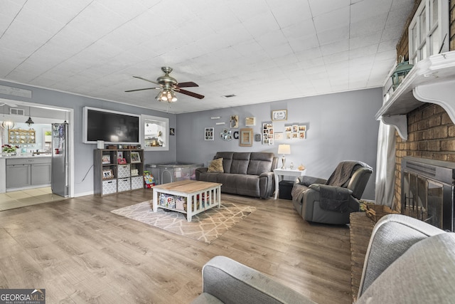314 Clifton Dr, Port Wentworth, GA 31407 - living area featuring wood finished floors, a brick fireplace, and a ceiling fan