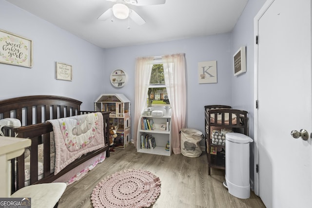 314 Clifton Dr, Port Wentworth, GA 31407 - bedroom with wood finished floors, a crib, and ceiling fan