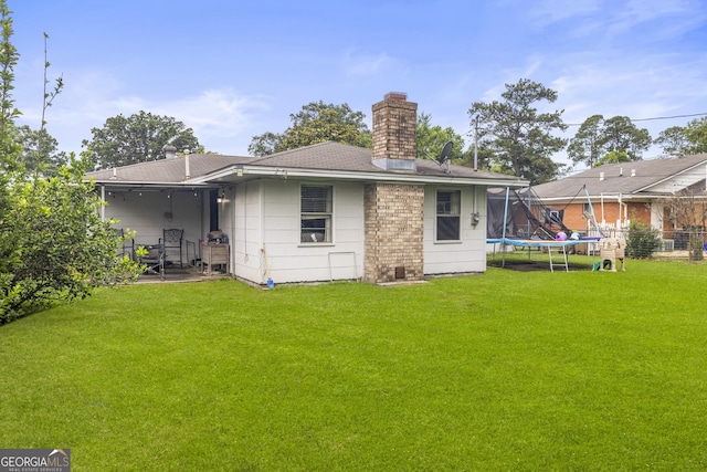 314 Clifton Dr, Port Wentworth, GA 31407 - rear view of house featuring a trampoline, a chimney, a patio, and roof with shingles