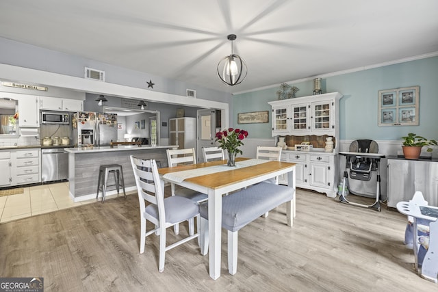 314 Clifton Dr, Port Wentworth, GA 31407 - dining room featuring light wood-style flooring and crown molding