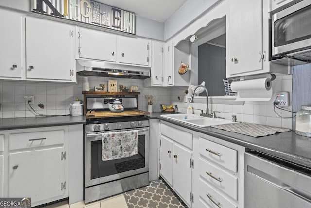 314 Clifton Dr, Port Wentworth, GA 31407 - kitchen featuring appliances with stainless steel finishes, under cabinet range hood, dark countertops, and white cabinets