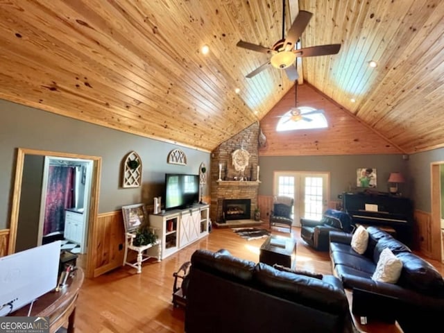 657 Halls Bridge Rd, Swainsboro, GA 30401 - living room with wooden ceiling, a ceiling fan, wainscoting, a stone fireplace, and wood finished floors