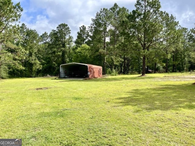 657 Halls Bridge Rd, Swainsboro, GA 30401 - view of green lawn with a carport