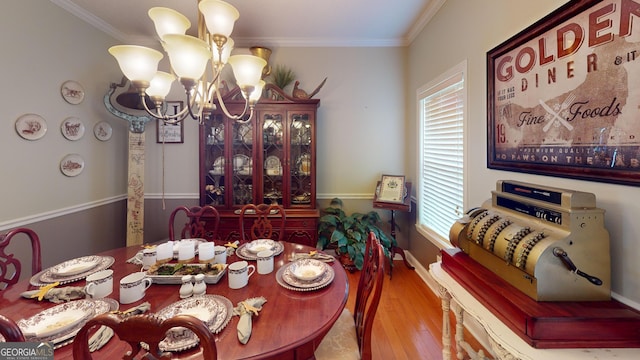 657 Halls Bridge Rd, Swainsboro, GA 30401 - dining room featuring a chandelier, wood finished floors, crown molding, and baseboards