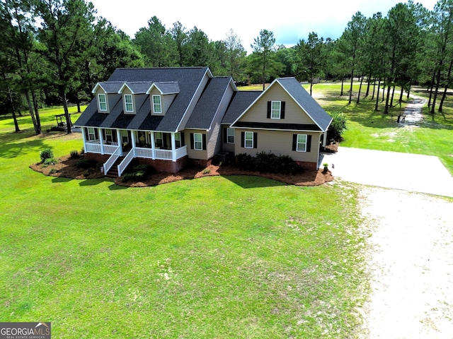 657 Halls Bridge Rd, Swainsboro, GA 30401 - cape cod home featuring driveway, view of wooded area, a porch, a front yard, and a shingled roof