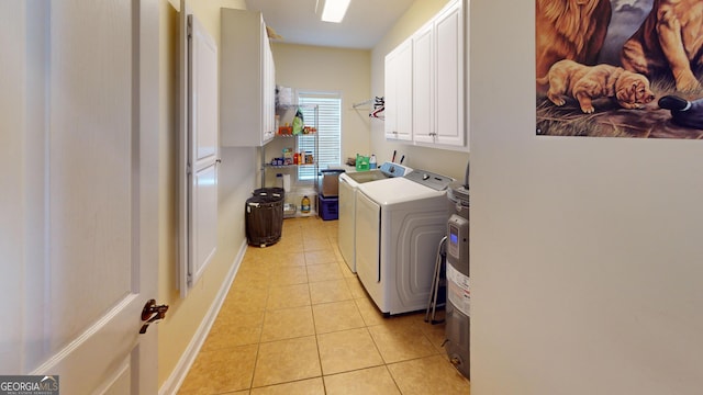 657 Halls Bridge Rd, Swainsboro, GA 30401 - washroom with separate washer and dryer, light tile patterned floors, cabinet space, and baseboards