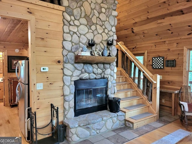 9 Dean Ct, Blue Ridge, GA 30513 - living room with wooden ceiling, wooden walls, wood finished floors, a stone fireplace, and stairs