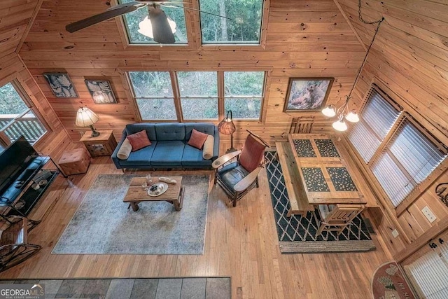 9 Dean Ct, Blue Ridge, GA 30513 - living room featuring wood-type flooring, wooden walls, a ceiling fan, and a towering ceiling