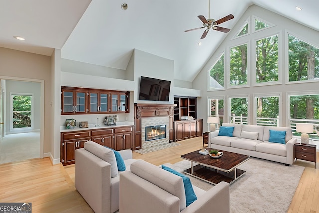 2230 Huntingdon Ct, Gainesville, GA 30506 - living room featuring high vaulted ceiling, light wood finished floors, ceiling fan, a fireplace with flush hearth, and plenty of natural light
