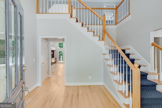 2230 Huntingdon Ct, Gainesville, GA 30506 - foyer entrance featuring wood finished floors, a towering ceiling, and stairs