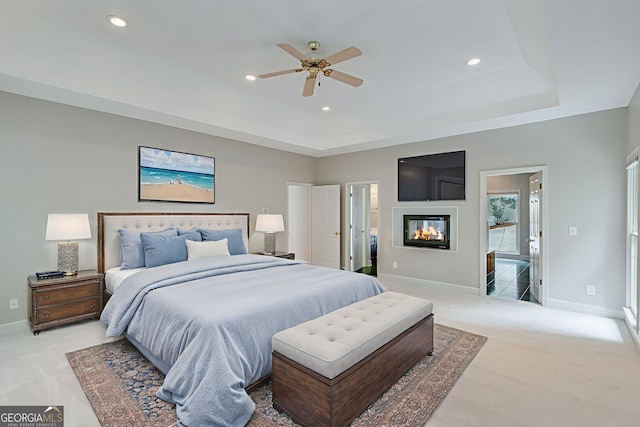 2230 Huntingdon Ct, Gainesville, GA 30506 - bedroom featuring carpet flooring, recessed lighting, a glass covered fireplace, a raised ceiling, and a ceiling fan