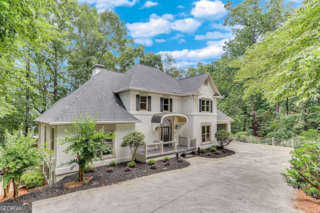 2230 Huntingdon Ct, Gainesville, GA 30506 - french country style house with stucco siding, concrete driveway, roof with shingles, and a chimney