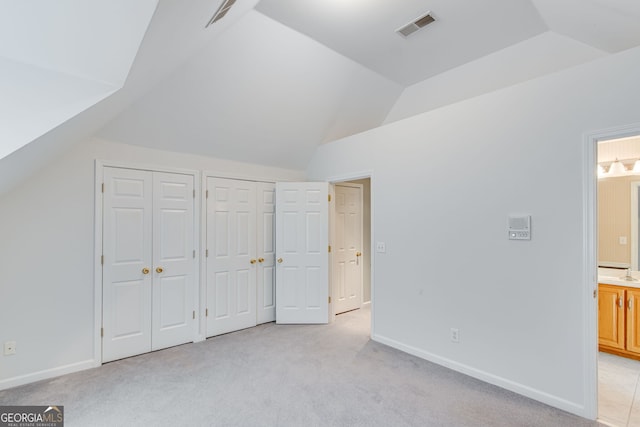 2230 Huntingdon Ct, Gainesville, GA 30506 - unfurnished bedroom with multiple closets, lofted ceiling, light carpet, and ensuite bath