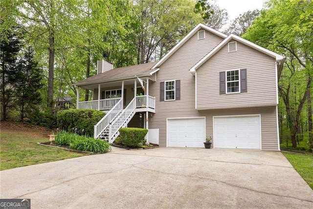 69 Due W Pass, Dallas, GA 30157 - view of front of house with driveway, a garage, a porch, stairs, and a chimney