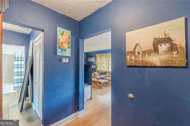1705 Monroe Dr NE Unit D05, Atlanta, GA 30324 - corridor with a textured ceiling, a textured wall, and wood finished floors